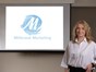 lady in front of the logo for millbrook marketing