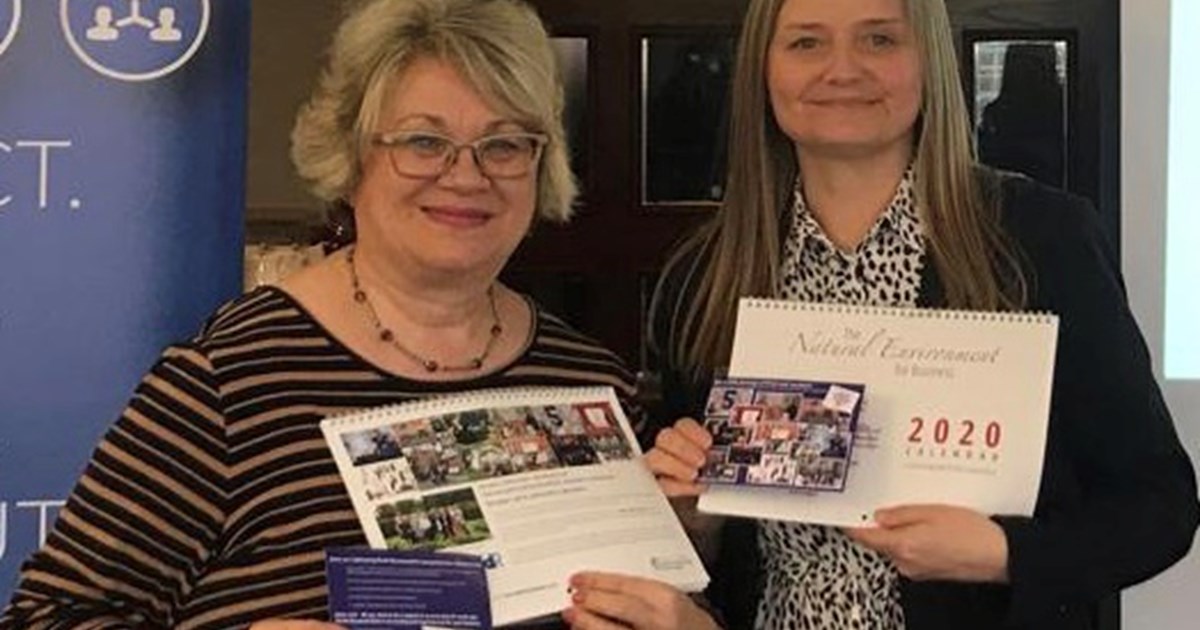 2 ladies holding calendars