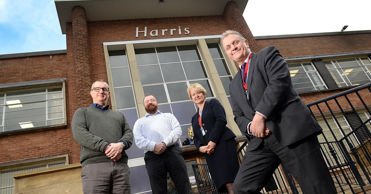 4 people outside harris building