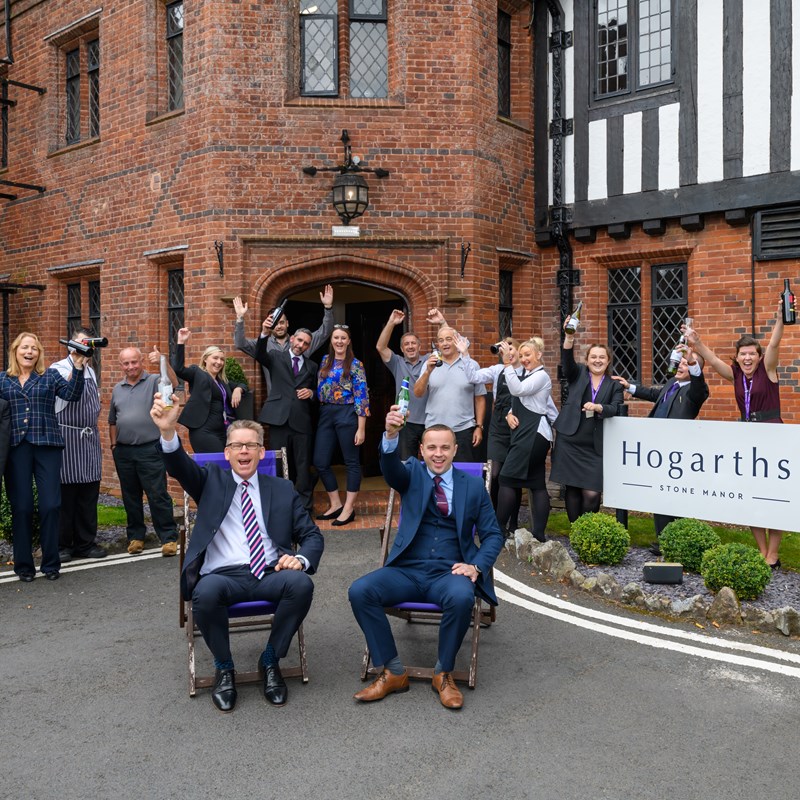 multiple people celebrating and cheering outside hogarths stone manor