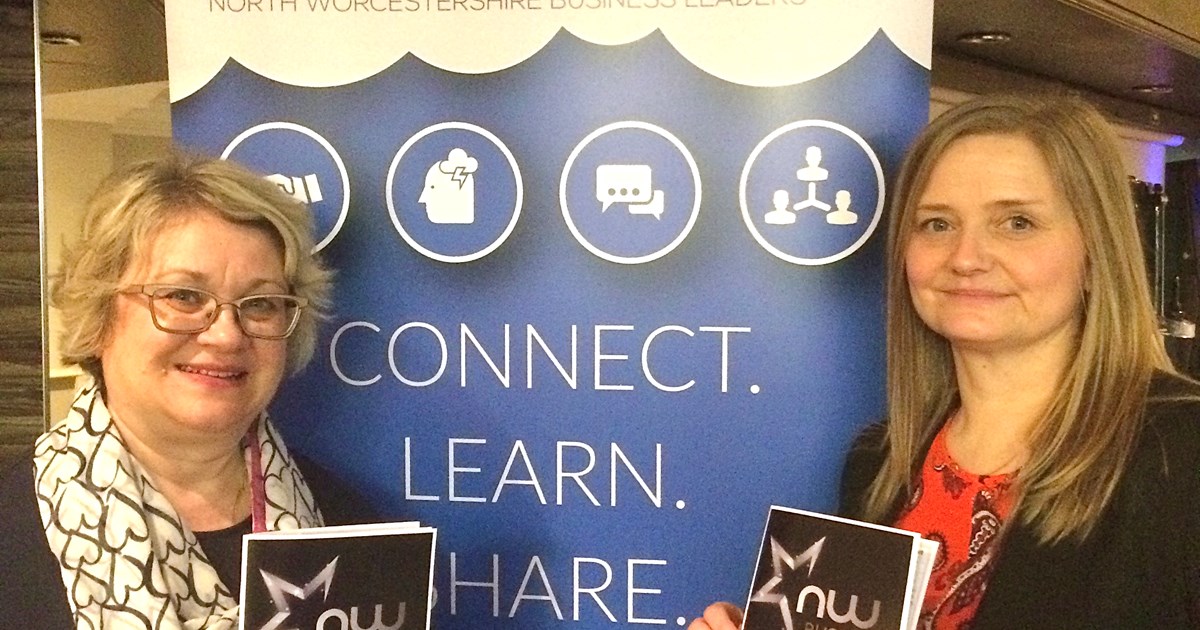 2 people holding a sponsorship package booklet