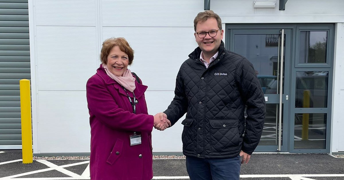 Image shows Councillor Mary Rayner and Andrew Lewis shaking hands in front of Silverwoods industrial unit