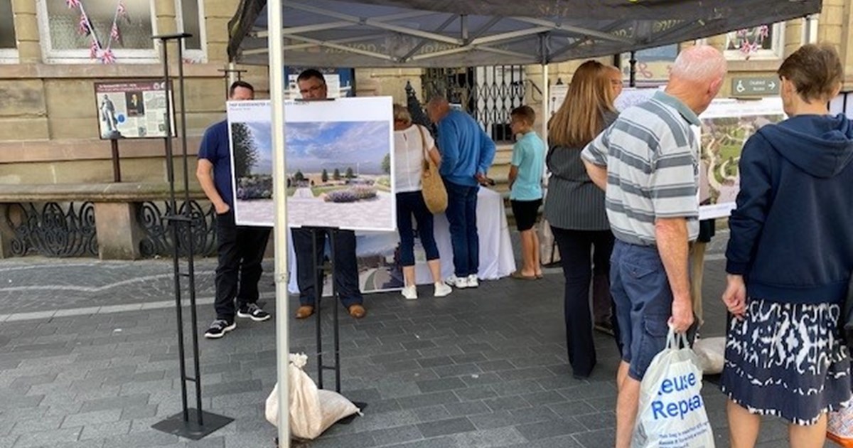 people stood under a cover looking at design proposal for a town centre regeneration